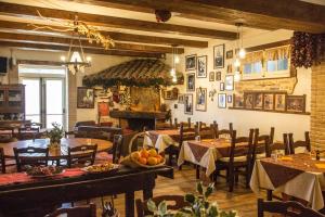 a restaurant with tables and chairs and a fireplace at Agriturismo La Locanda Del Parco in Morano Calabro