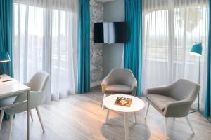 a living room with two chairs and a table at Van der Valk Hotel Saint-Aygulf in Saint-Aygulf