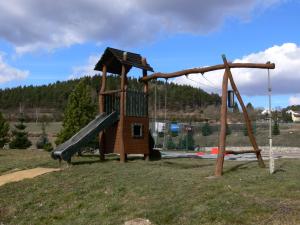 a small playground with a slide in a field at Resort Hulín in Sedlčany