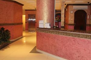 a lobby with red walls and a counter in a building at Makarem Najd Funished Units 2 in Riyadh