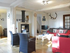 a living room with a couch and a table at Charming holiday home in the Ardennes in Laneuville au bois in Tenneville