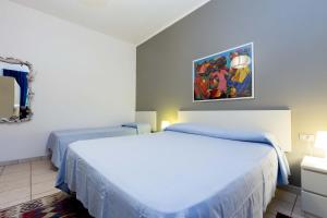 A bed or beds in a room at Il Gabbiano Piano Terra - Goelba