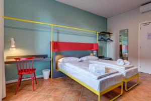 A bed or beds in a room at MEININGER Milano Garibaldi