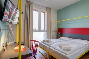 A bed or beds in a room at MEININGER Milano Garibaldi