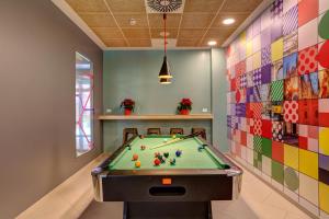 a pool table in a room with colorful tiles at MEININGER Milano Garibaldi in Milan