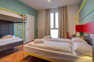 A bed or beds in a room at MEININGER Milano Garibaldi