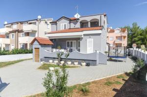 a villa with a large driveway in front of a house at Ljiljana in Srima