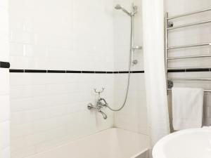 a bathroom with a shower and a white tub at Magnificent sea view! Luminous 1 br for max 4 in Helsinki