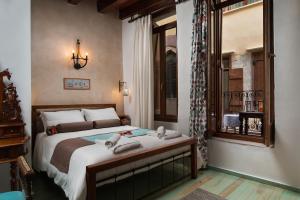 a bedroom with a large bed and a window at Dream Art Studios in Chania