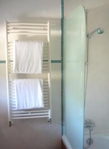 a bathroom with a shower and a towel on a window at Hotel Rural Can Pujolet in Santa Agnès de Corona +48 photos