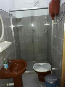 a bathroom with a sink and a toilet and a shower at Casa da Val in Morro de São Paulo