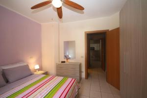 a bedroom with a bed and a ceiling fan at Universal Apartments Itri C in Itri