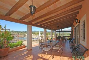 a patio with a table and chairs on a deck at Villa Tramuntana in Inca