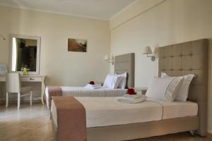 a hotel room with two beds and a desk at Element Hotel in Elafonisos