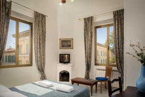 a bedroom with a bed and a fireplace and windows at Adre Majestic View ! Center of Florence ! in Florence