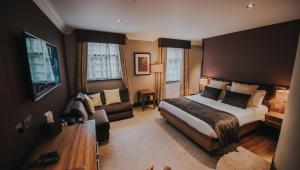 a hotel room with a bed and a couch at Busby Hotel in Busby