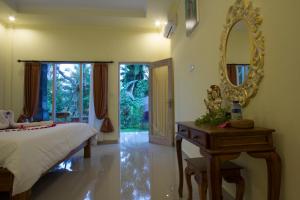 Postel nebo postele na pokoji v ubytování Vinayaka Ubud