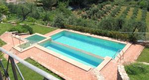 The swimming pool at or close to Villa il Pino by VacaVilla