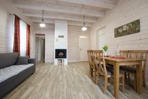 a living room with a table and a couch at Panemunio sodyba in Birštonas