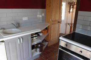 a kitchen with a sink and a counter top at La Bouillerie du Clos in Branville