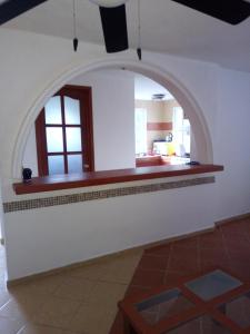 a kitchen with an archway in the middle of a room at punta sam in front isla mujeres in Cancún