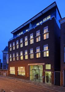 a large brick building with many windows at Asgard Hotel in Groningen