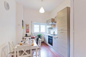 a kitchen with a table and chairs in a kitchen at Liberty Trastevere B&B in Rome +24 photos