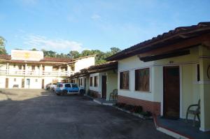 a car parked in a parking lot next to a building at Pousada Do Bosque in Itajuípe +13 photos