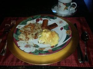 a plate of food with sausage and rice on a table at Baer House Inn in Vicksburg