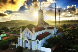 a large white church with a tower on top of it at Pousada Do Bosque in Itajuípe