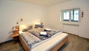 a bedroom with a large bed and a window at Landhaus Antonia in Seefeld in Tirol