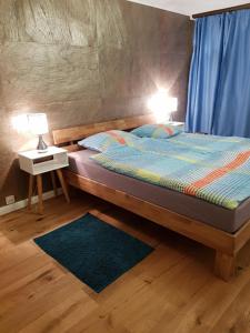 a bedroom with a bed with two lamps on it at Ferienwohnung Alpenblick in Davos +14 photos