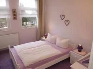 ザンクト・アンドレーアスベルクにあるFerienwohnung Elaのベッドルーム1室(白いシーツ付きのベッド1台、窓2つ付)