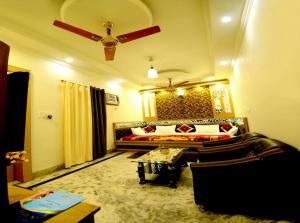 a living room with a bed and a couch at Taj Square A luxurious family homestay in Agra
