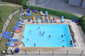 an overhead view of people in a swimming pool at Le Grand Panorama 5 Étage Terrasse Vue sur La Montagne in Saint-Gervais-les-Bains