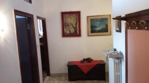 a room with a table and pictures on the wall at Appartamento Centro Storico vicino Università in Perugia