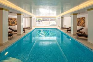 a large swimming pool in a hotel room with a pool at Theoxenia House Hotel in Athens