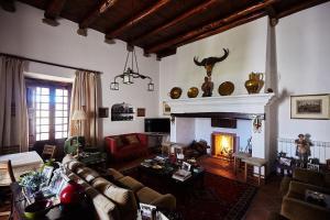 a living room with a couch and a fireplace at Cork Hills Farmhouse in Monte da Pedra