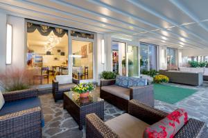 a living room with couches and chairs and a table at Hotel Vallechiara in Lido di Savio