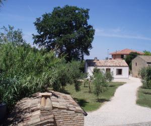a stone wall with a house and a tree at La Capanna in Francavilla al Mare