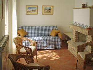 a living room with a couch and a table and chairs at La Capanna in Francavilla al Mare