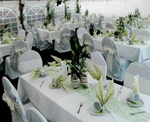 a room filled with white tables and chairs with white tables and chairs at Pension am Radweg & Ristorante Juani in Wriezen