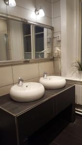 two sinks sitting on a counter in a bathroom at Centralstationens Vandrarhem in Norrköping