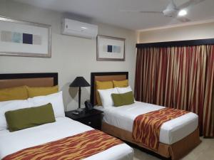 Katil atau katil-katil dalam bilik di Hotel El Viejo Inn
