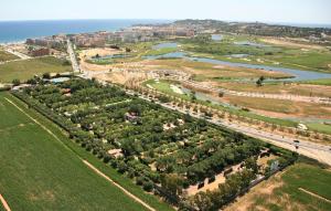 an aerial view of a park with trees and a highway at Camping La Pineda de Salou in La Pineda