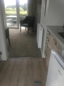 a bathroom with a sink and a chair and a mirror at Clydestay in Alexandra