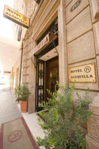 a hotel entrance with plants in front of a building at Hotel Altavilla in Rome