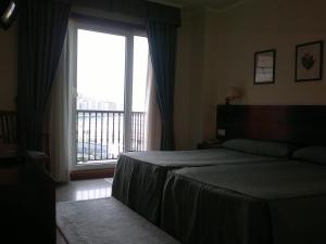 Łóżko lub łóżka w pokoju w obiekcie Hotel Bahía Bayona
