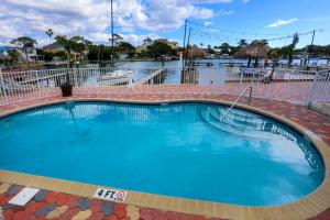 a large swimming pool with blue water in a resort at Bay Palms Waterfront Resort - Hotel and Marina in St Pete Beach +14 photos