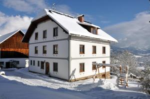 a white house with snow on top of it at Ferienhof Berger in Rossleithen +39 photos